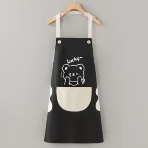 Detail view of black waterproof kitchen apron with cute bear print and large front pocket.