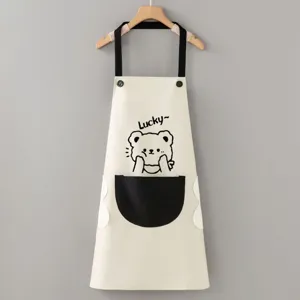 Detail view of the waterproof kitchen apron featuring a cute bear print and wipe-hand side.