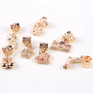 Gold alloy DIY charms pendants close up detail view, various cute shapes for jewelry making.