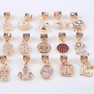 Gold alloy DIY jewelry charms detail view, featuring dragon, ingot and lucky coin pendant designs.