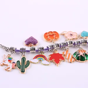 Close-up detail of colorful enamel alloy DIY charm bracelet pendants cute cartoon style