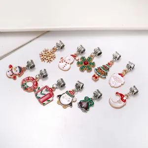 Close-up view of assorted Christmas metal enamel charms, featuring cute holiday shapes.