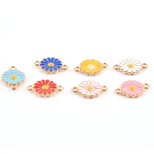 Close-up detail of colorful enamel daisy flower double loop metal charms for DIY jewelry crafting.