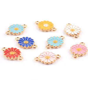 Close-up of colorful enamel daisy flower double loop metal charms for DIY jewelry making.