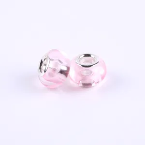 Detail closeup of pink acrylic large hole charm beads with silver core for DIY bracelets.