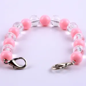 Primo piano dettagliato di un braccialetto con perle rosa e trasparenti da 10 mm.