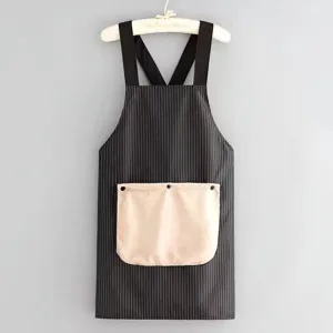 Kitchen apron detail view showing waterproof fabric, black stripes and front storage pocket.