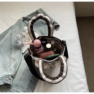 Striped canvas tote bag interior capacity detail, casual shoulder bag for women daily commute.
