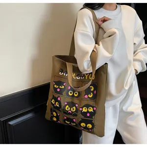 Gros plan sur le sac cabas en toile avec motif de chat noir mignon et drôle en grille.