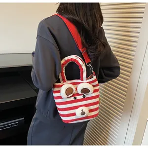 Detailed view of the cute red and white striped canvas tote bag with plush bear ears.