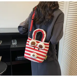 Detailed view of the red white striped canvas tote bag featuring a cute plush bear face detail.
