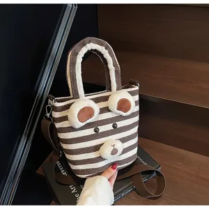 Closeup of cute brown and white striped plush bear tote bag with shoulder strap and handles.