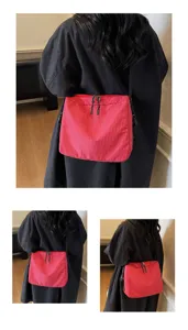 Detailed view of the red checkered crossbody bag showing its multi-angle design and straps.