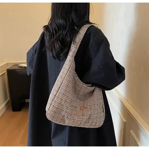 Detailed view of the vintage plaid hobo shoulder bag, showcasing soft woolen fabric and texture.