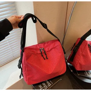 Red grid crossbody shoulder bag detail, casual large capacity daily tote bag for women.