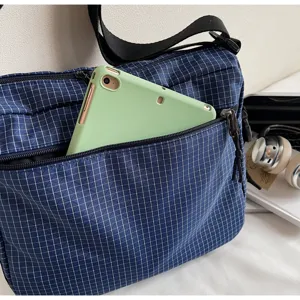 Casual blue grid messenger bag detail view with front zipper pocket and tablet storage for daily use.