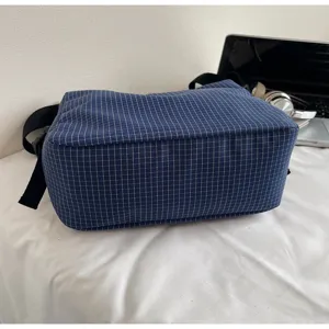 Detailed view of casual blue grid shoulder bag, stylish crossbody bag for daily wear and commuting.