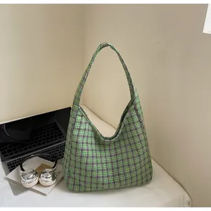 Green plaid woolen underarm shoulder bag detail showing soft textured fabric and casual style.