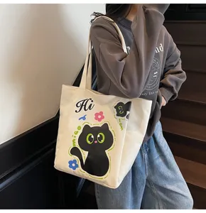 Sac cabas en toile décontracté avec impression de chat noir mignon, sac à épaule tendance.