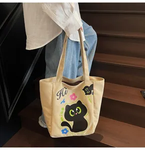 Détail de sac cabas en toile avec imprimé chat noir mignon, parfait pour un usage quotidien.