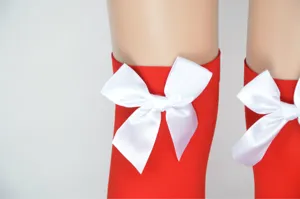 Red over knee stockings with white bow detail, perfect for Halloween and Christmas parties.