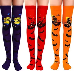 Halloween over-the-knee socks detail view featuring spooky bat and castle prints for party wear.