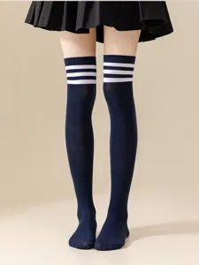 Detail view of Japanese style navy blue over-the-knee socks featuring three white stripes.
