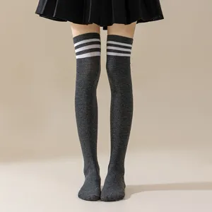 Detailed view of dark grey over-the-knee socks featuring classic white triple stripe design.