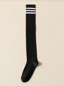Detailed view of classic black over-the-knee socks featuring three white stripes at the top.