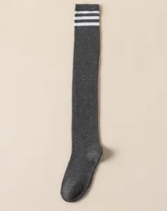Dark grey over-the-knee socks detail shot, featuring classic white triple stripes design.