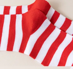Detalle de calcetines altos a rayas rojas y blancas, ideales para fiestas y cosplay.