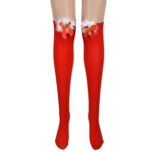 Detailed view of red Christmas over-the-knee thigh high socks with white fluffy feather and bow decor.