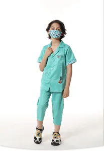 Kids veterinarian costume detail showing green scrubs top with VET pocket and paw print graphics.