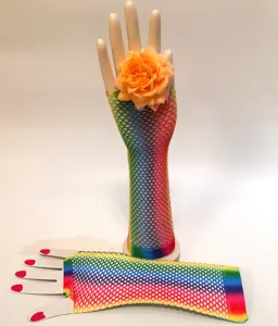 Detail shot of rainbow fishnet long gloves with orange rose decor, party wear and festival look.