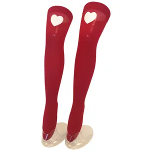 Details of red thigh high stockings with white heart print, sheer over the knee hosiery close up