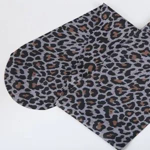 Leopard print sheer pantyhose fabric detail shot, sexy fashion hosiery texture showcase.