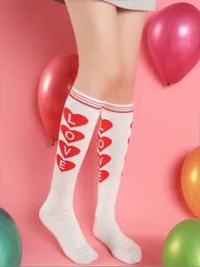 Close-up detail of white knee high socks featuring red heart and LOVE letter prints, perfect.