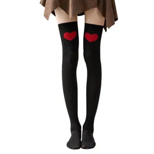 Close-up detail of black over-the-knee cotton socks featuring cute red heart pattern for women.