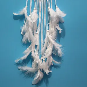 White feather dreamcatcher hanging detail closeup room decor ornament gift unique design style.