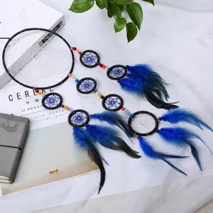 Handmade black and blue dream catcher wall hanging with feathers and beads for home decor.