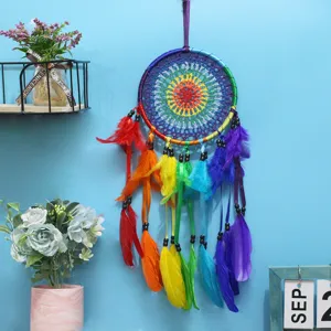 Handcrafted colorful feather dream catcher wall hanging detail, boho home decor item.