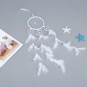 Handmade white dream catcher hanging ornament with delicate feathers for beautiful home decor.
