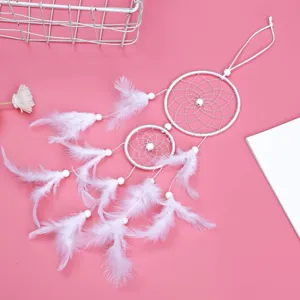 White double ring dream catcher feather hanging ornament for car and bedroom decor.