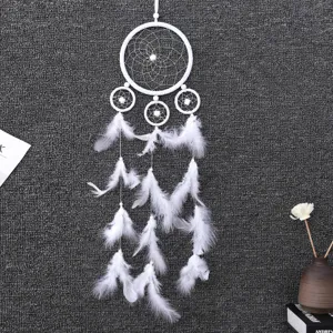 Detailed view of a white handmade dream catcher pendant with feathers for home wall decor.