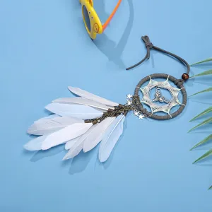 Car dreamcatcher hanging ornament with white feathers, stars, and moon charms for interior decor.