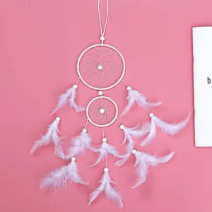 White double ring dream catcher feather hanging ornament car pendant bedroom decor detail.