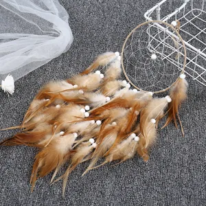 Details of bohemian brown feather dream catcher wall hanging decor with white beads.