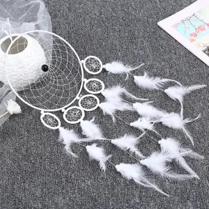 Detailed close-up of a white dream catcher with feathers, elegant home decor wall hanging.