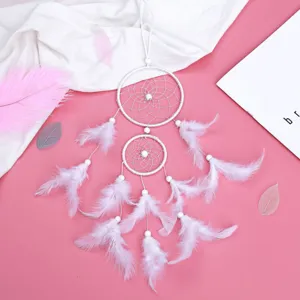 White double ring dream catcher wall hanging decoration with soft feathers and beads.