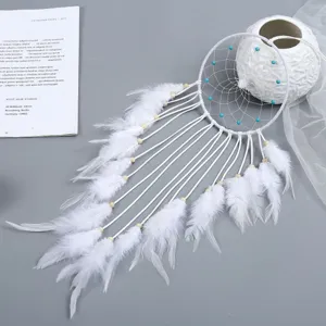 White dreamcatcher wall hanging decoration with soft feathers and blue beads for indoor home decor.